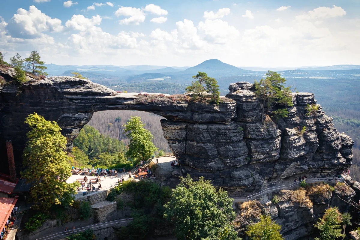 The Pravčická brána sandstone arch with the Falcon's Nest chalet beneath it